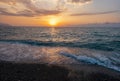 The picturesque sea at sunset. Sunset on the Black Sea with the sun, Abkhazia. Colorful sunset with waves