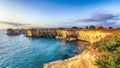 Picturesque seascape with cliffs rocky arch and stacks faraglioni at Torre Sant Andrea