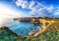 Picturesque seascape with cliffs rocky arch and stacks faraglioni at Torre Sant Andrea