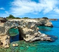 Picturesque seascape with cliffs, rocky arch and stacks faraglioni, at Torre Sant Andrea, Salento sea coast, Puglia, Italy Royalty Free Stock Photo