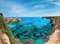 Picturesque seascape with cliffs, rocky arch and stacks faraglioni, at Torre Sant Andrea, Salento sea coast, Puglia, Italy Royalty Free Stock Photo