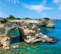 Picturesque seascape with cliffs, rocky arch and stacks faraglioni, at Torre Sant Andrea, Salento sea coast, Puglia, Italy Royalty Free Stock Photo