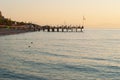 Picturesque seascape in Turkey. Amazing sunrise on beach, orange clouds reflected in calm water