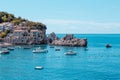 Picturesque seascape view of Adriatic sea coast in Budva Riviera. Przno village with buildings on the rock and boats on