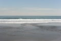 Picturesque seashore with beach and ocean waves and horizon on a sunny day with clear blue sky and calm ocean in Hokkaido, Japan