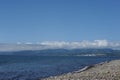 Picturesque seashore with rocks and beach on a sunny day with clear blue sky and calm ocean in Muroran, Hokkaido