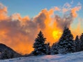 Picturesque shot of the sunset above countryside covered in fresh powder snow.