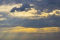 Picturesque sky with thunderstorms cumulus clouds. Overcast sky with big clouds. Sun shines through clouds with oblique rays.