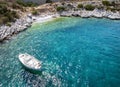 A picturesque, small beach with a traditional fishing boat at the coastal road of Athens