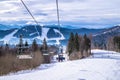 Picturesque snowy panorama of the Carpathian Mountains and a chair lift. Winter holidays in the mountains Royalty Free Stock Photo