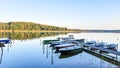 Picturesque Spiegelsee landscape with empty rowing boats at a jetty in the evening. The island in the background is covered with a Royalty Free Stock Photo