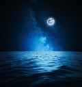 Picturesque starry sky with full moon over sea at night Royalty Free Stock Photo