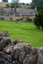 Stone cottages around the village green, photographed in the pretty Cotswold village of Snowshill near Broadway, UK