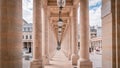 Picturesque stone walkway lined with a row of classical-style lanterns in Palais-Royal, Paris.