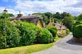 Picturesque street in a Cotswolds village with thatched roof house, England Royalty Free Stock Photo