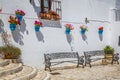 Picturesque street of Mijas with flower pots in facades. Andalusian white village. Costa del Sol. Southern Spain Royalty Free Stock Photo