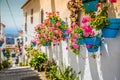 Picturesque street of Mijas with flower pots in facades. Andalusian white village. Costa del Sol. Southern Spain Royalty Free Stock Photo