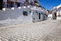 Picturesque street of Mijas with flower pots in facades. Andalusian white village. Costa del Sol. Southern Spain Royalty Free Stock Photo