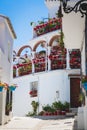 Picturesque street of Mijas with flower pots in facades. Andalusian white village. Costa del Sol. Southern Spain Royalty Free Stock Photo