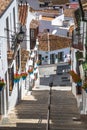 Picturesque street of Mijas with flower pots in facades. Andalusian white village. Costa del Sol. Southern Spain Royalty Free Stock Photo