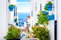 Picturesque street of Mijas with flower pots in facades Royalty Free Stock Photo