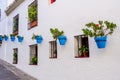 Mijas town street lined with white washed walls and blue flower pots. Costa del Sol, Spain. Royalty Free Stock Photo