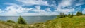 summer landscape. panoramic view of the lake under a beautiful cloudy sky with a coast in the foreground Royalty Free Stock Photo