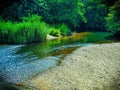 Picturesque summer scene of peaceful tranquil clear water flowing over rocks Royalty Free Stock Photo