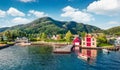 Picturesque summer view of typical Norwegian village Jondal, on the shore of fjord. Sunny morning panorama of countryside, Norway Royalty Free Stock Photo
