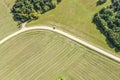 Picturesque sunny rural landscape. dirt road crossing agricultural fields. top aerial view Royalty Free Stock Photo