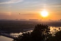 Picturesque sunrise over the Dnipro River in Kiev, Ukraine, with colorful hot air balloons in sky Royalty Free Stock Photo