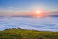 Picturesque sunrise over the sea of fog in the mountains Royalty Free Stock Photo