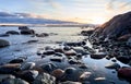 Picturesque sunset on a large rocky beach, featuring an array of stones on the shoreline Royalty Free Stock Photo