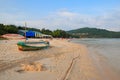 Trees, umbrellas, old boat and people on Sao beach, Phu Quoc, Vietnam - December 2018. Royalty Free Stock Photo