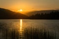 Picturesque sunset scene bathes the lake in warm, golden hues