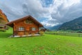 Picturesque swiss countryside manor with a charming red house amidst lush green grass Royalty Free Stock Photo