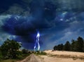 Picturesque thunderstorm in desert. Lightning striking from dark cloudy sky Royalty Free Stock Photo
