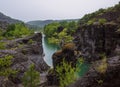 A picturesque and tranquil place with a calm river in a rocky gorge during a colorful summer. Rainy summer in a nature park Royalty Free Stock Photo