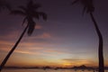 Picturesque tropical sunset. Dramatic evening sky above island. Palm tree and isles silhouettes. Exotic seascape in twilight. Royalty Free Stock Photo