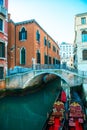 Picturesque view of ancient buildings, bridge and channel with gondolas in Venice, Italy. Beautiful romantic italian city