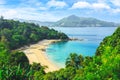 Picturesque view of Andaman sea in Phuket island, Thailand. View through the jungle on the beautiful bay and mountains. Royalty Free Stock Photo