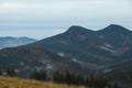 Picturesque view of beautiful mountain landscape with forest and fog patches on autumn day Royalty Free Stock Photo