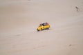 Picturesque view of big car driving on sandy dunes and tire tracks Royalty Free Stock Photo