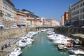 Picturesque view on boats in city channel in Livorno, Italy