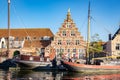 Picturesque view of boats in and old canal house in Leiden, Holland Royalty Free Stock Photo