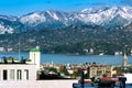 Picturesque view of the city, the roofs of the houses, the sea, the mountains covered with snow. Royalty Free Stock Photo