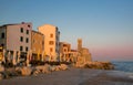 Picturesque view of coastline of Adriatic sea with street cafe and lighthouse at sunrise, Piran, Slovenia Royalty Free Stock Photo