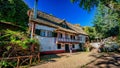 Picturesque view of a cobblestone walkway with lush foliage, leading up to quaint homes in Portugal