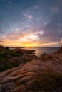 Picturesque view on colourful sky at sunset time. Jagged coastal rocks, Isola Rossa, Sardinia, Italy Royalty Free Stock Photo