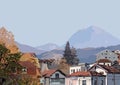 A picturesque view of a cozy city with small houses in front of the mountains